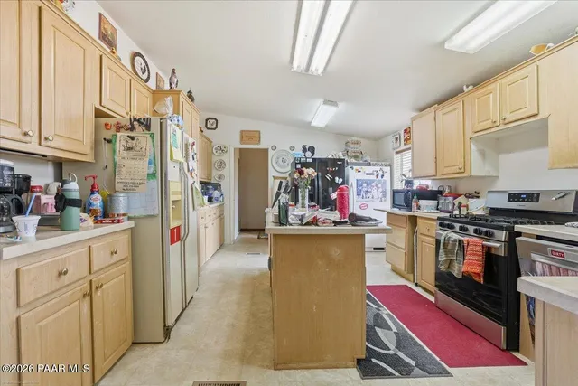 a open kitchen with stainless steel appliances granite countertop a stove and cabinets