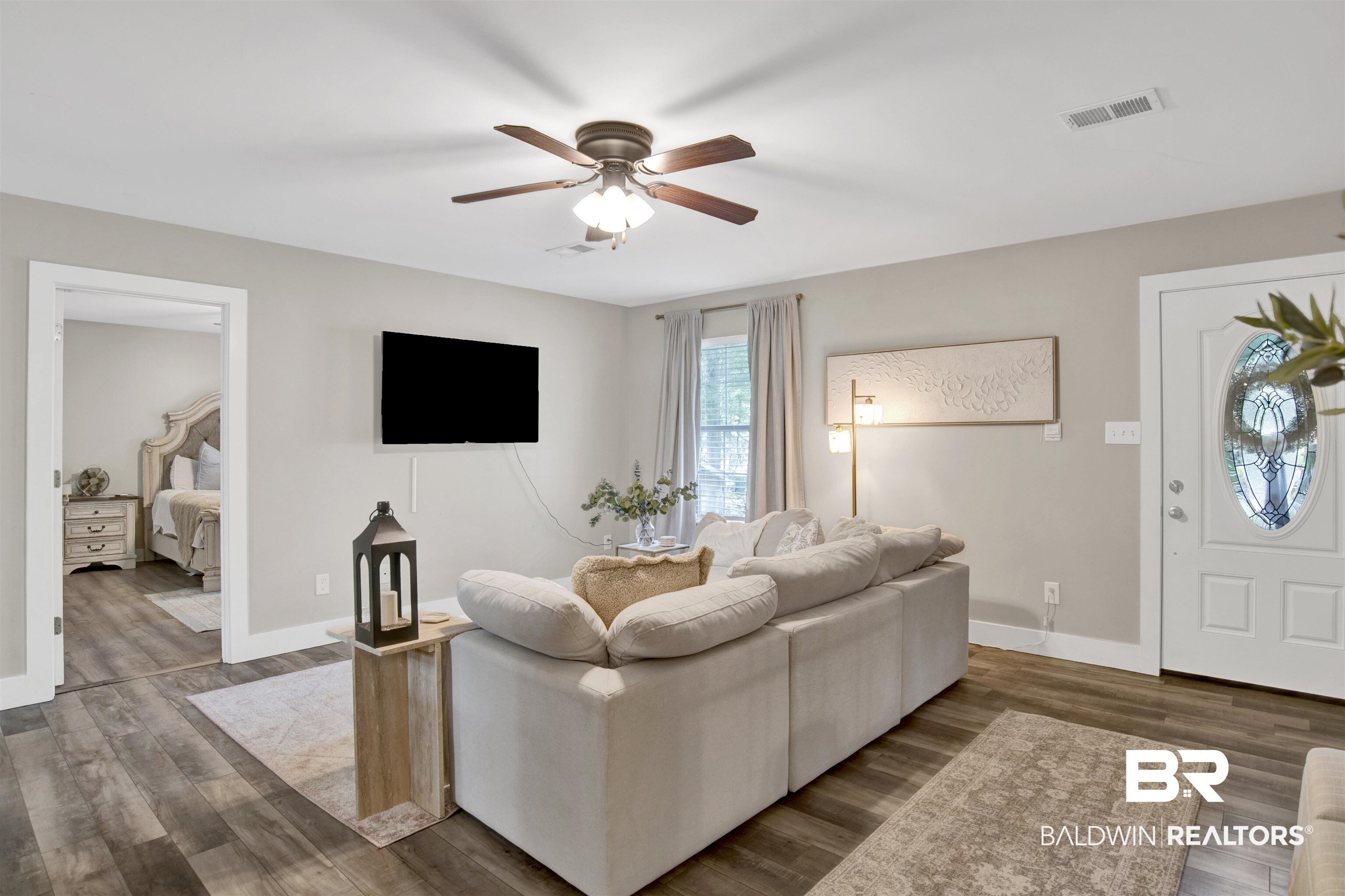 253 Maplewood Loop Daphne, AL 36526 - Photo 15 of 30 Spacious living area featuring wood-finish flooring, a ceiling fan with integrated lighting, and neutral wall tones