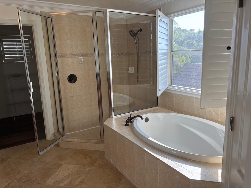 8606 Stone Harbour Loop Bradenton, FL 34212 - Photo 12 of 22 a spacious bathroom with a bathtub and shower