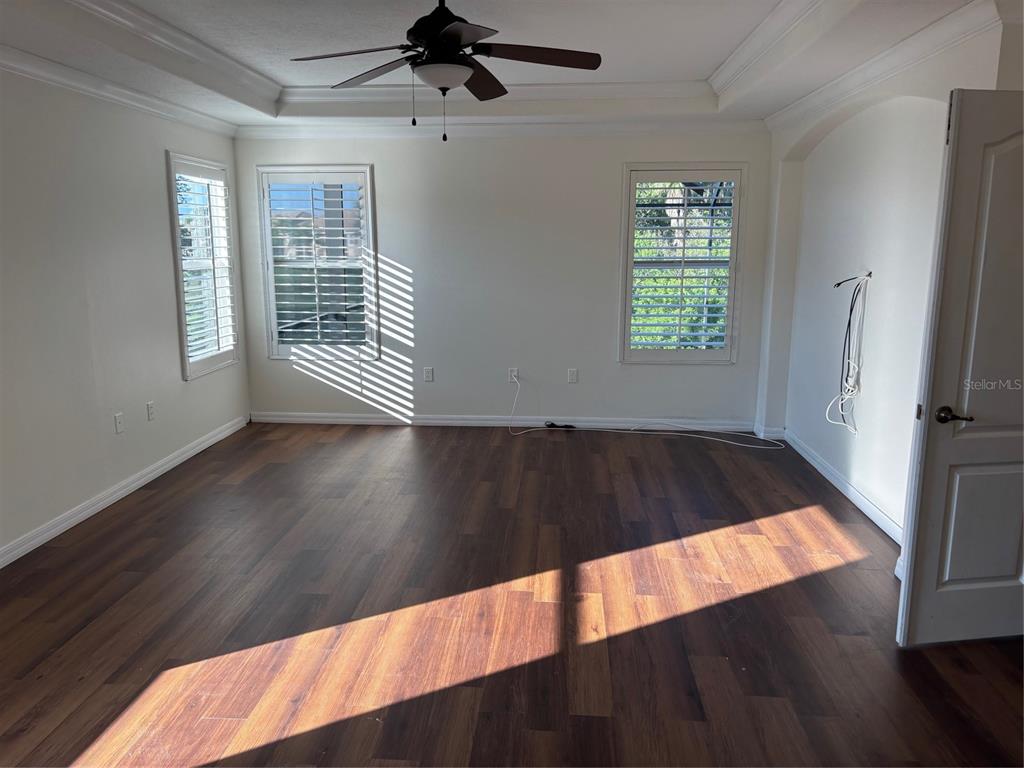 8606 Stone Harbour Loop Bradenton, FL 34212 - Photo 13 of 22 a view of an empty room with wooden floor and a window