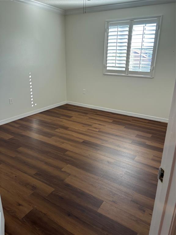 8606 Stone Harbour Loop Bradenton, FL 34212 - Photo 16 of 22 an empty room with wooden floor and windows