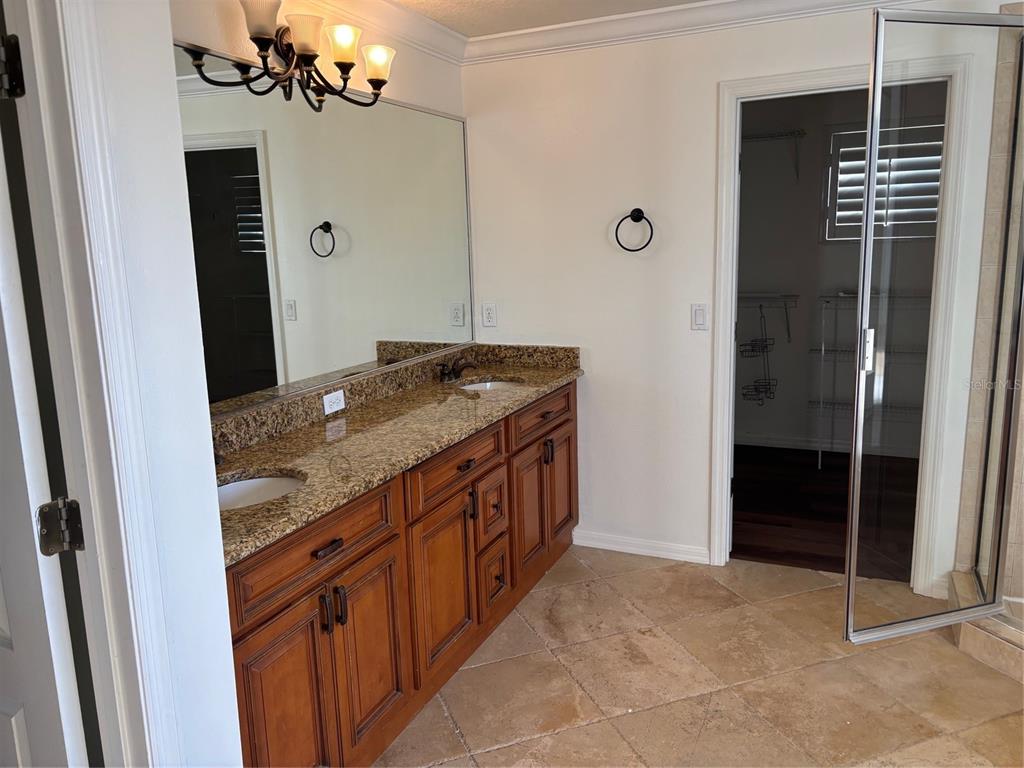 8606 Stone Harbour Loop Bradenton, FL 34212 - Photo 21 of 22 a bathroom with a granite countertop sink a mirror and shower