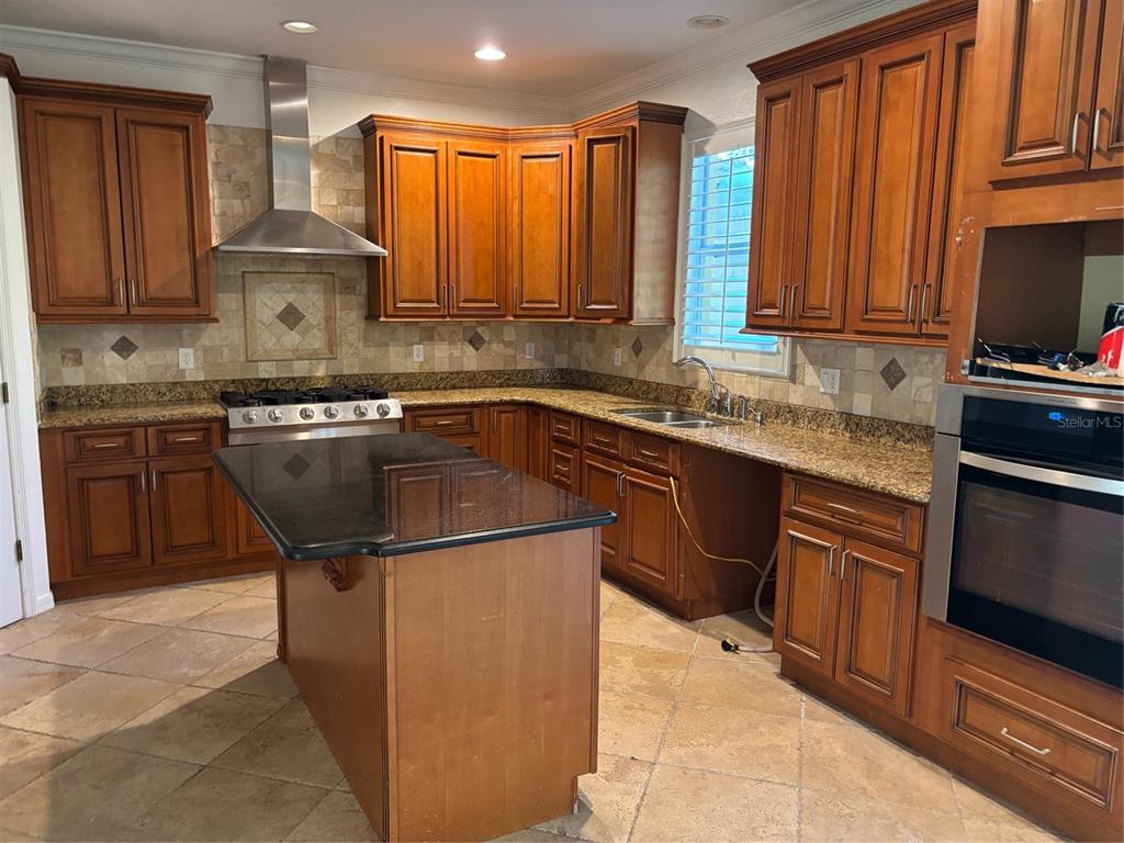8606 Stone Harbour Loop Bradenton, FL 34212 - Photo 7 of 22 a kitchen with stainless steel appliances granite countertop a sink stove and cabinets