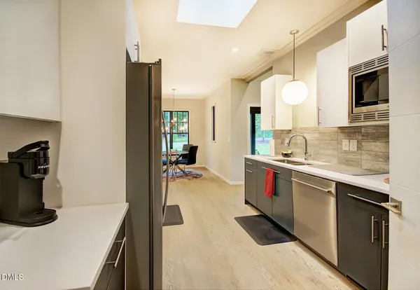 a kitchen with a sink cabinets and a microwave