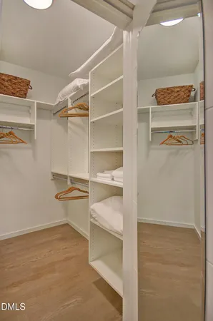 a bedroom with a bed and a mirror