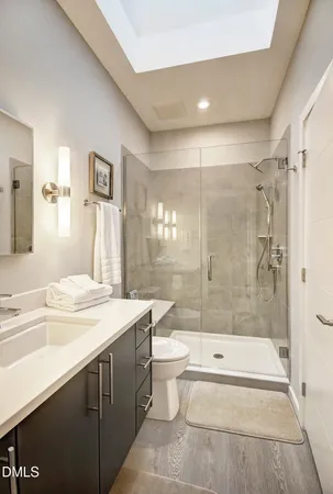 a bathroom with a sink toilet and shower