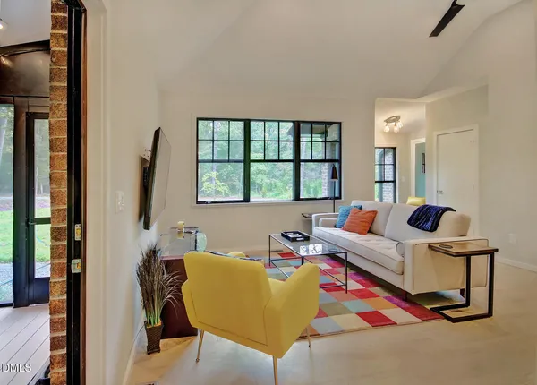 a living room with furniture and a potted plant