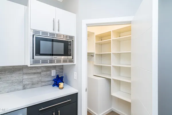 a kitchen with stainless steel appliances a sink stove and refrigerator