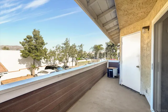 a view of a balcony with mountain view and wooden floor