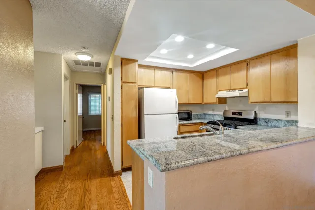 a kitchen with a refrigerator a sink and cabinets