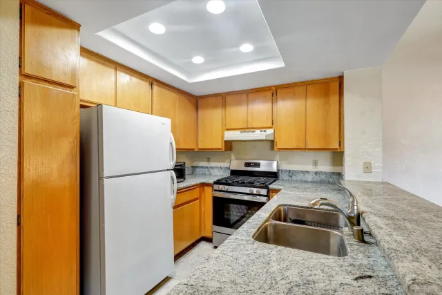 a kitchen with a refrigerator a sink and a cabinets