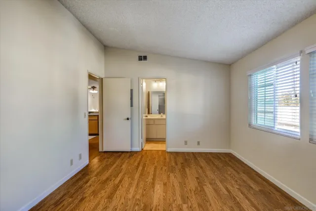 a view of a room with wooden floor and window