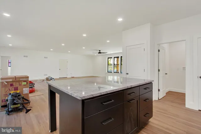 a kitchen with a sink and dishwasher with wooden floor
