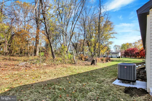 a view of backyard with wooden fence