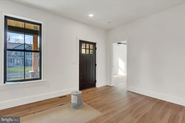 an empty room with windows and closet