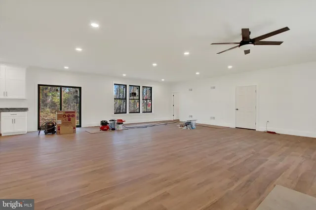 a view of a room with wooden floor and gym equipment