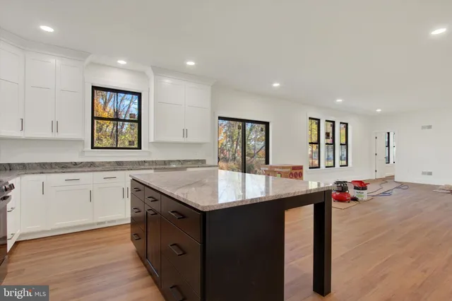 a kitchen with counter top space sink and center island
