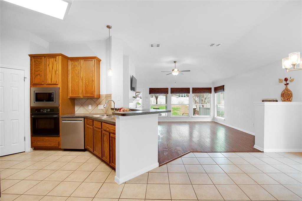 281 Hutton Kyle, TX 78640 - Photo 18 of 37 An inviting open-concept layout connects the well-appointed kitchen to a naturally illuminated living space.