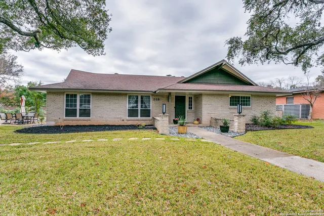 a front view of a house with swimming pool having outdoor seating