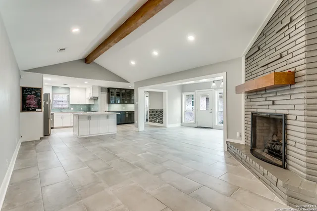 a view of a kitchen with a sink and a fireplace