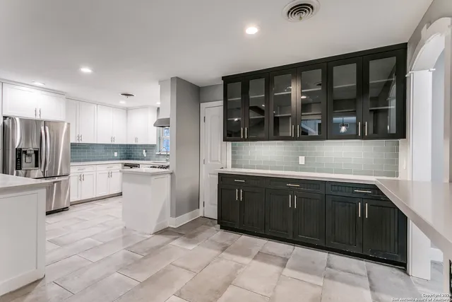 a kitchen with a sink counter top space and stainless steel appliances