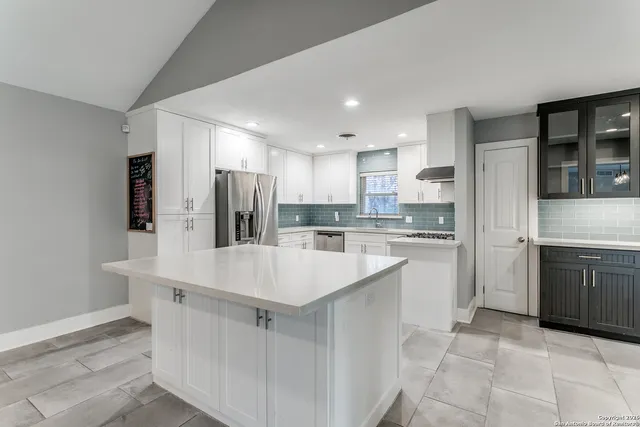 a large white kitchen with a sink