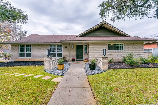a front view of house with yard and outdoor seating