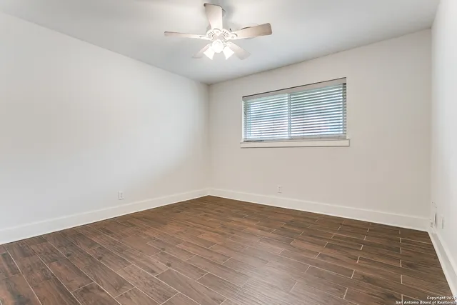 wooden floor in an empty room with a window