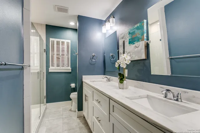 a bathroom with a double vanity sink and a mirror
