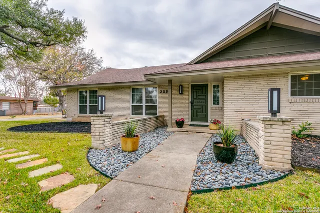 a front view of a house with swimming pool and furniture