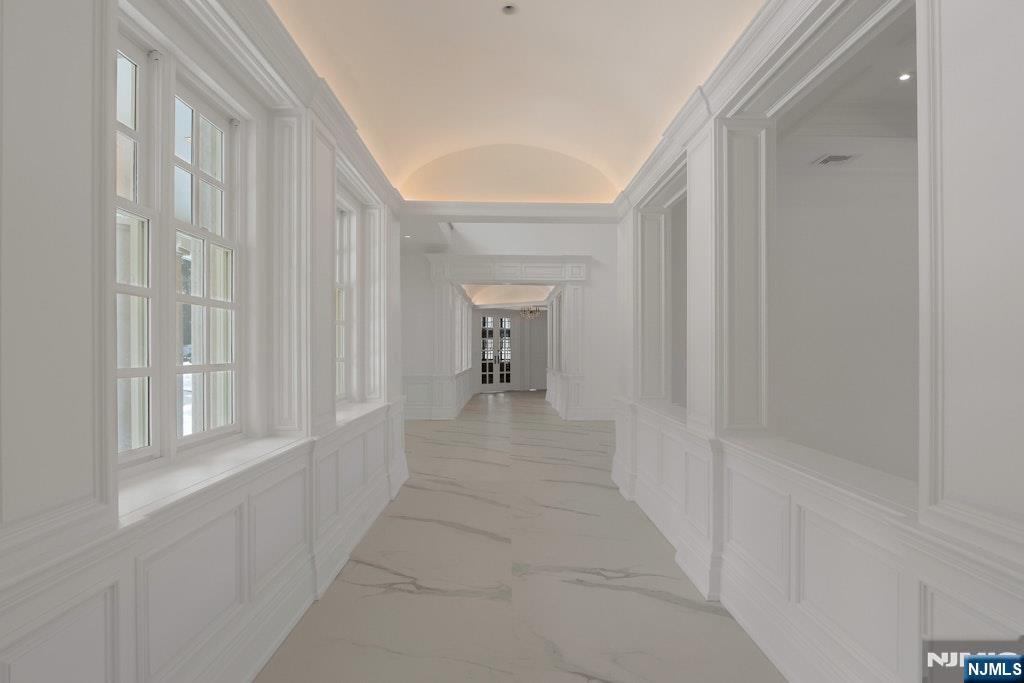 67 Robin Lane Alpine, NJ 07620 - Photo 11 of 40 a view of a hallway with two windows and a yard