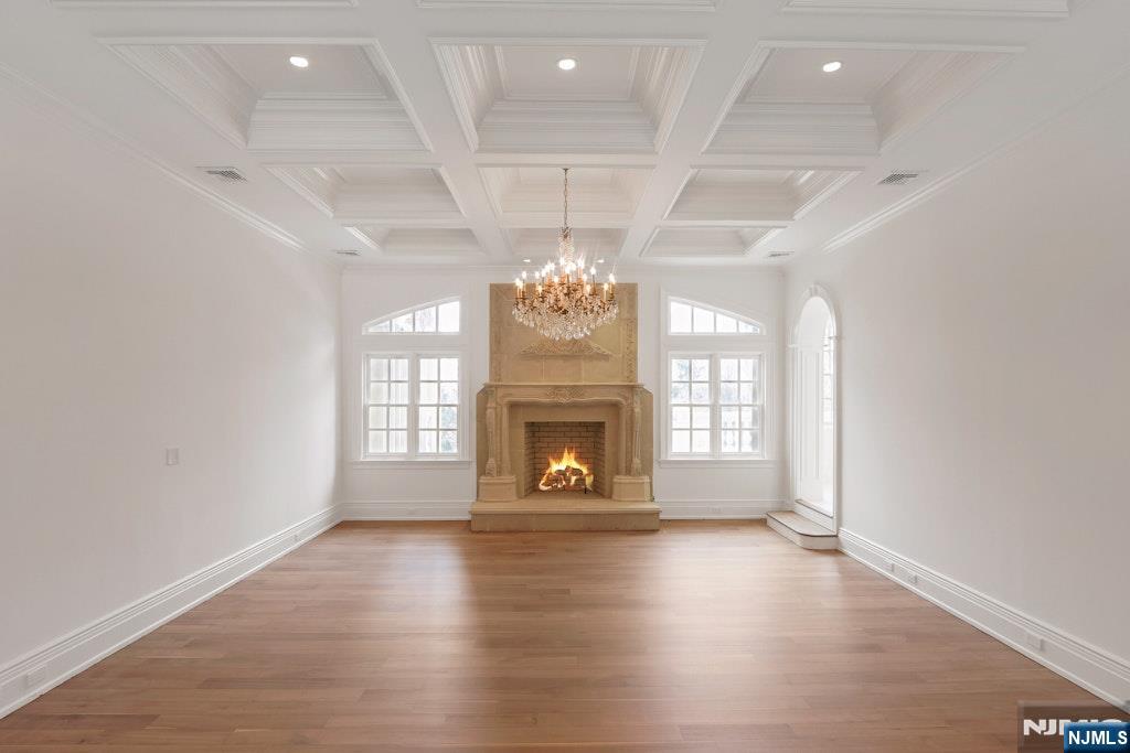 67 Robin Lane Alpine, NJ 07620 - Photo 25 of 40 an empty room with wooden floor fireplace and windows