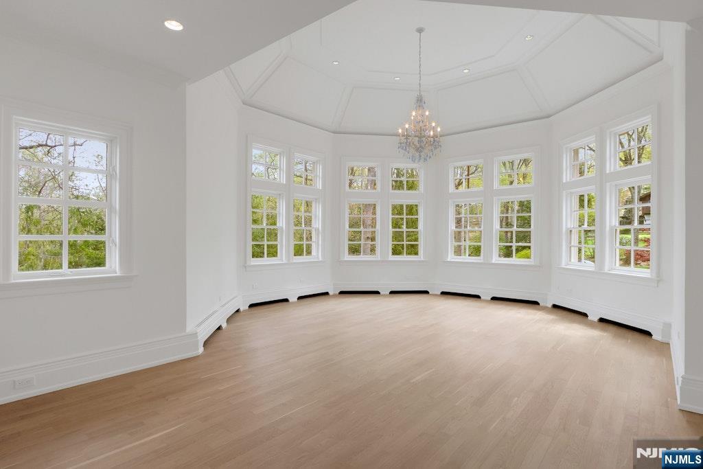67 Robin Lane Alpine, NJ 07620 - Photo 32 of 40 an empty room with wooden floor and windows