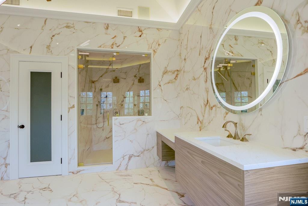 67 Robin Lane Alpine, NJ 07620 - Photo 34 of 40 a bathroom with a sink a mirror a vanity and a shower