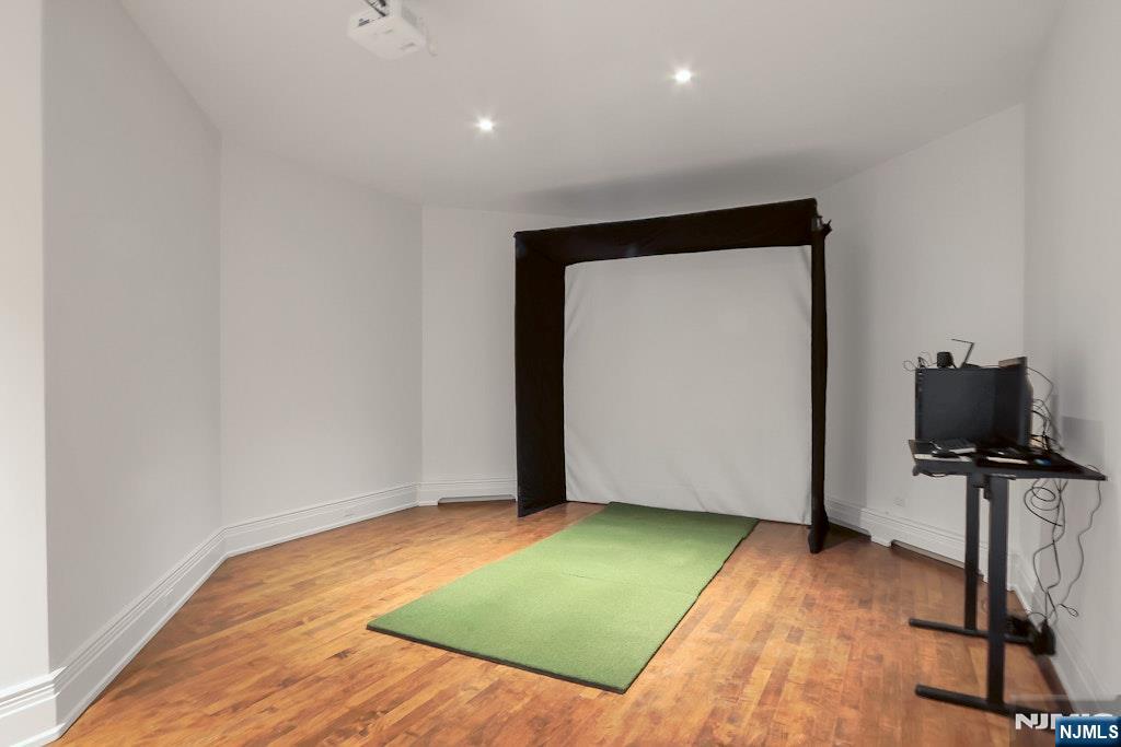 67 Robin Lane Alpine, NJ 07620 - Photo 36 of 40 a view of a room with wooden floor and a flat screen tv