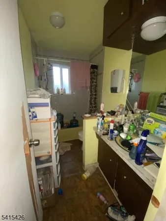 a room with stainless steel appliances kitchen island granite countertop furniture and a wooden floor