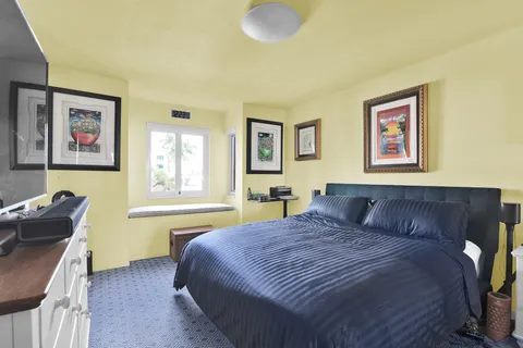 a large kitchen with a large window a refrigerator and a sink