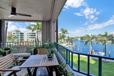 a view of swimming pool with outdoor seating and palm tree