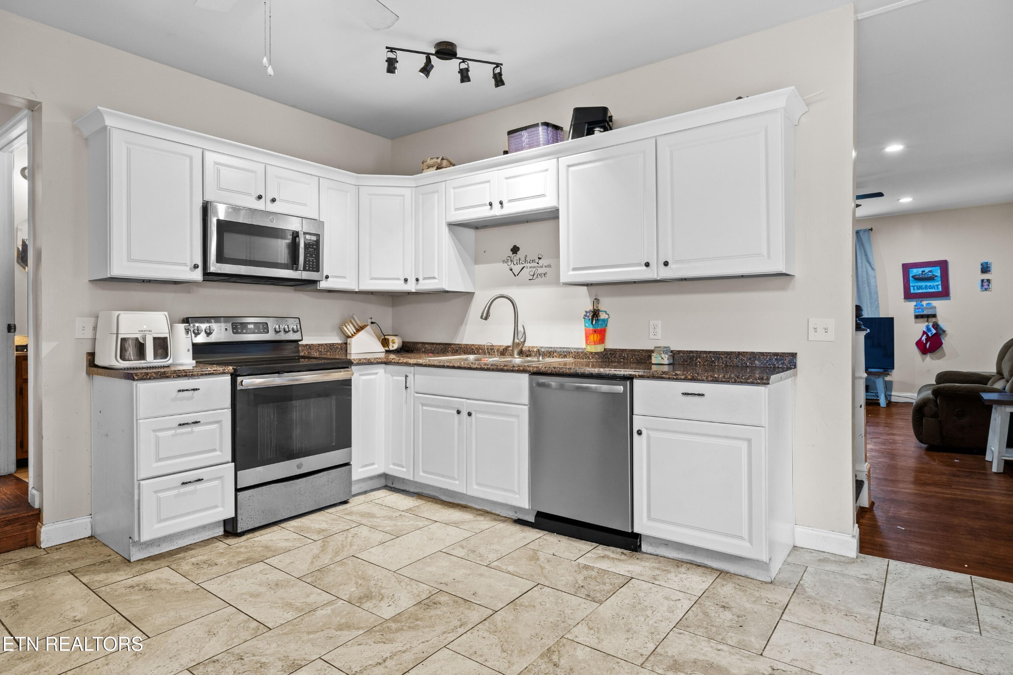 706 Broad Street Sweetwater, TN 37874 - Photo 12 of 28 a kitchen with granite countertop white cabinets and stainless steel appliances