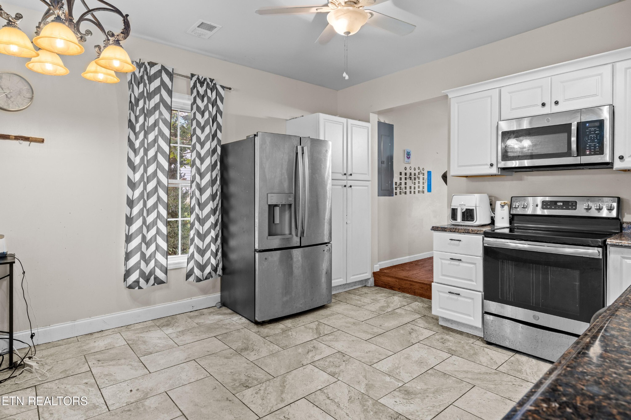 706 Broad Street Sweetwater, TN 37874 - Photo 14 of 28 a kitchen with stainless steel appliances granite countertop a refrigerator stove and microwave