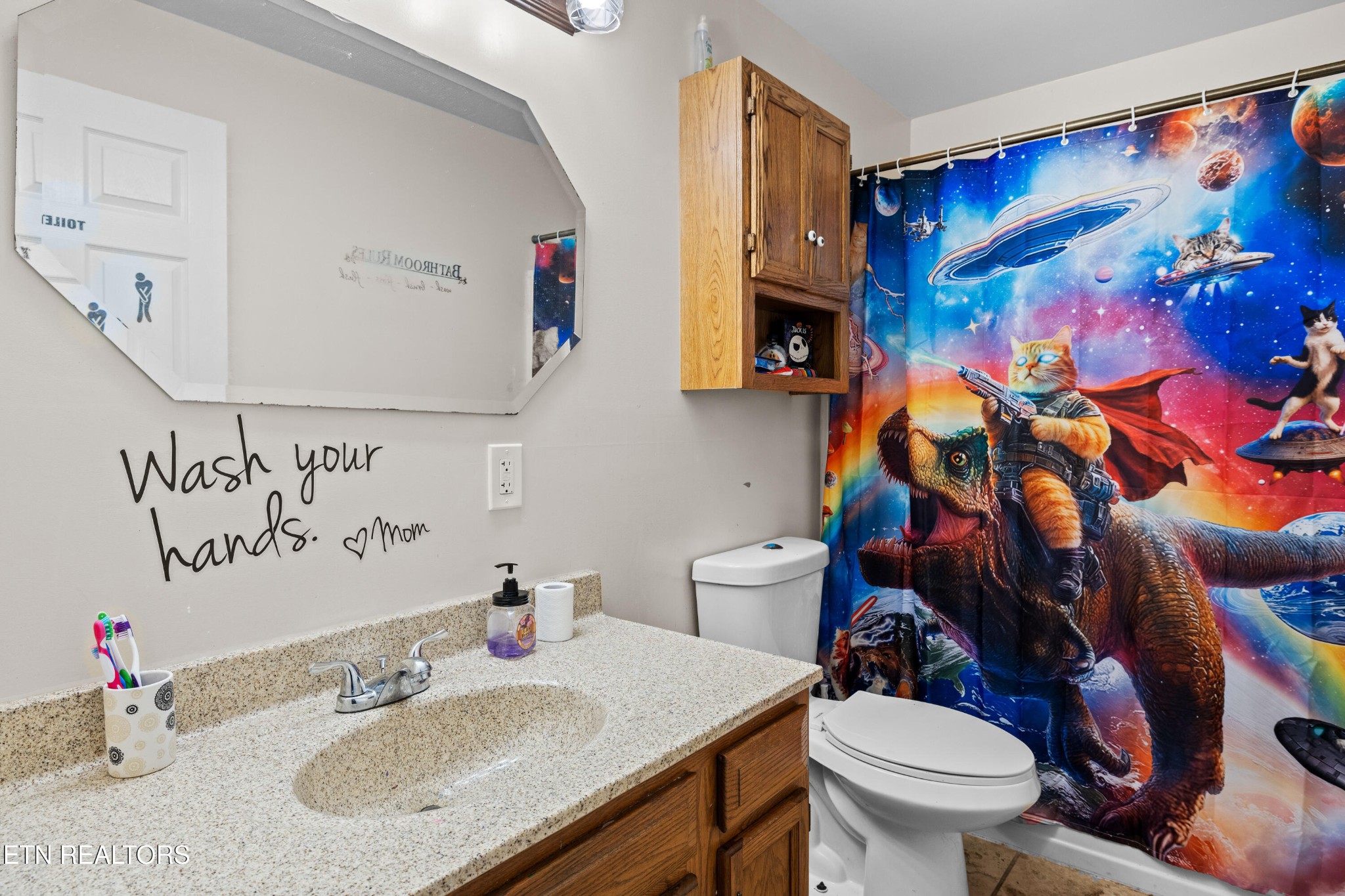 706 Broad Street Sweetwater, TN 37874 - Photo 16 of 28 a bathroom with a sink mirror vanity and toilet