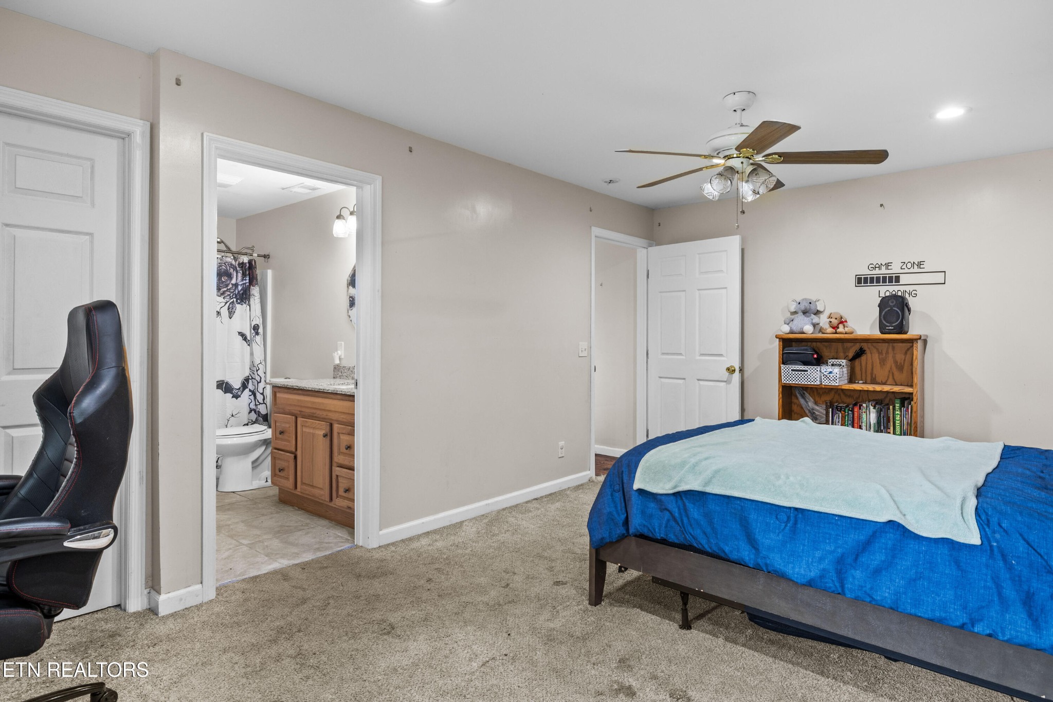 706 Broad Street Sweetwater, TN 37874 - Photo 18 of 28 a bedroom with a bed and a chandelier