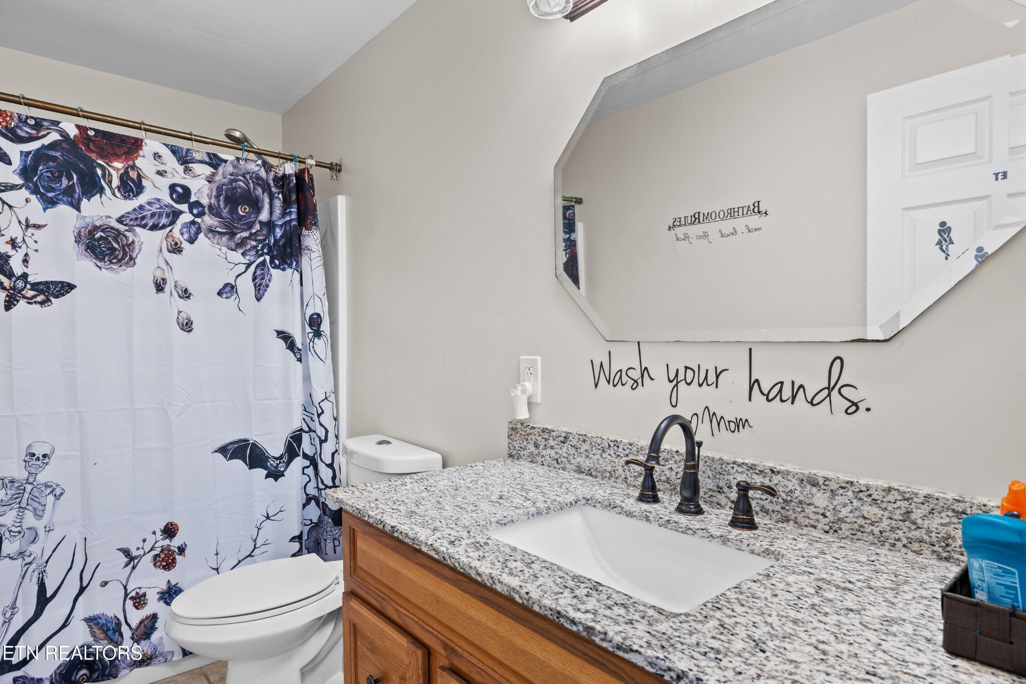 706 Broad Street Sweetwater, TN 37874 - Photo 20 of 28 a bathroom with a granite countertop sink a toilet and a mirror