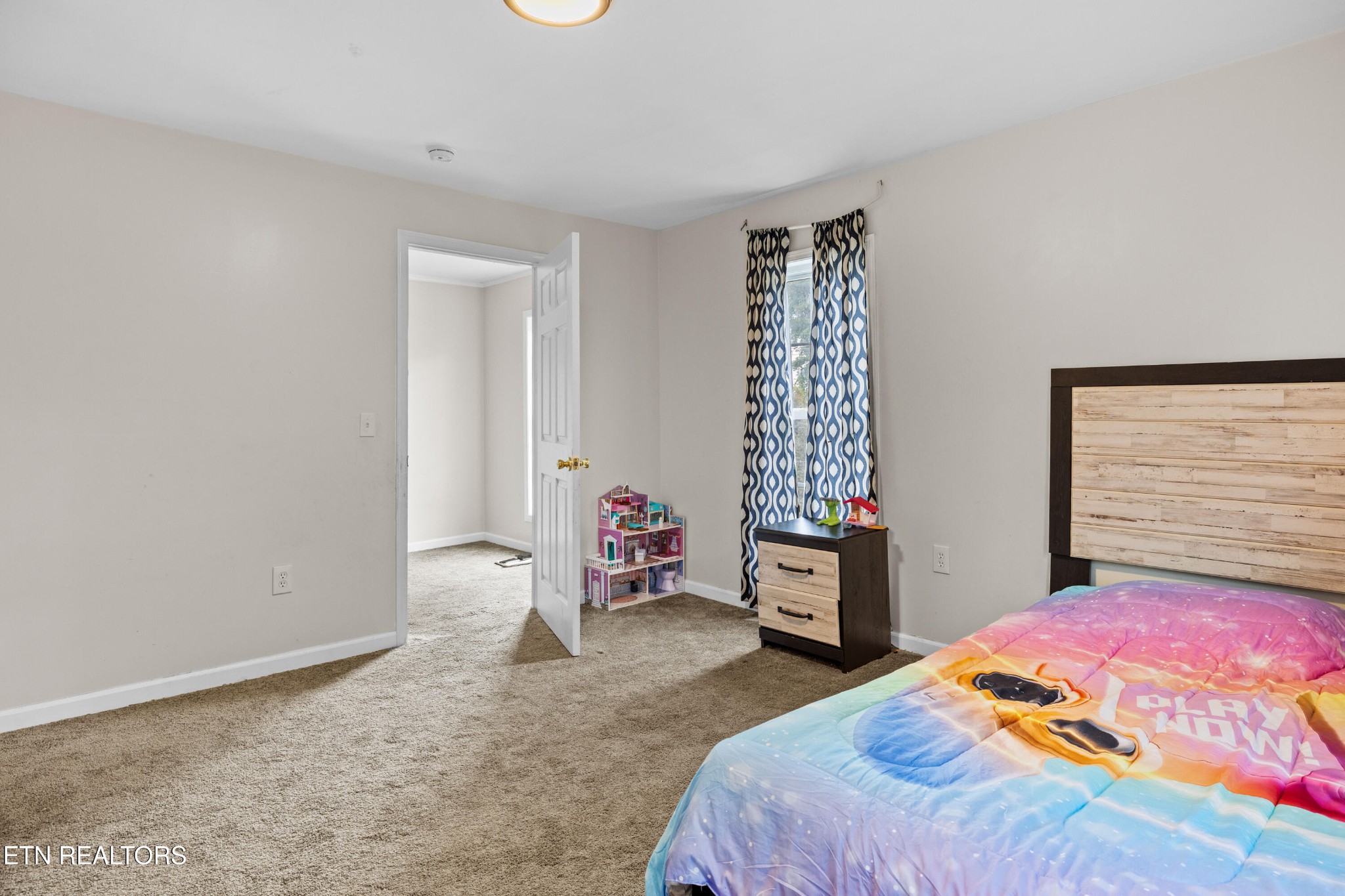 706 Broad Street Sweetwater, TN 37874 - Photo 23 of 28 a bedroom with a bed and wooden floor