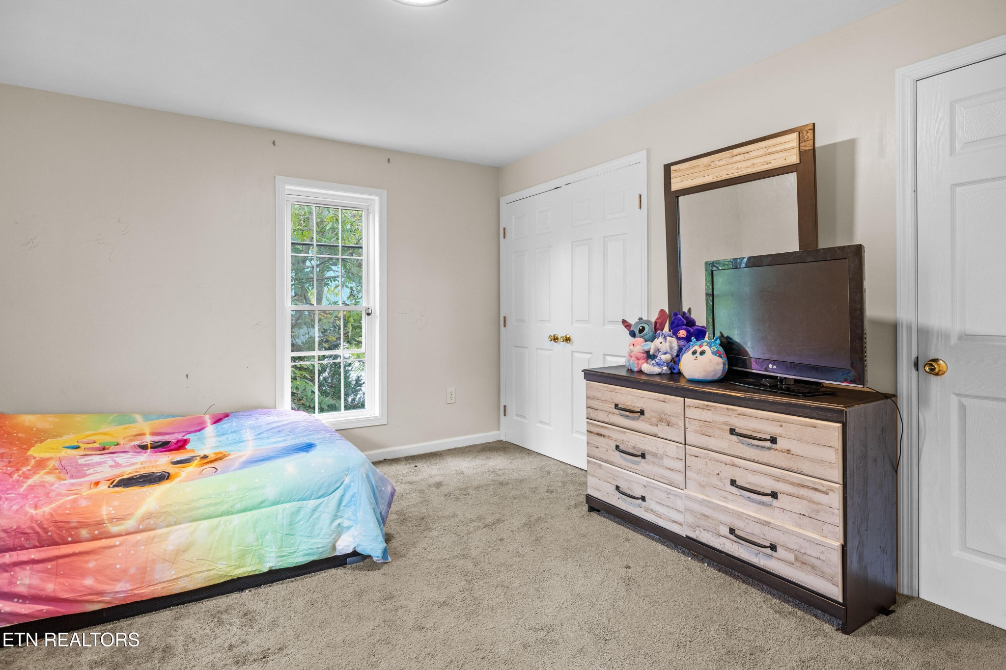 706 Broad Street Sweetwater, TN 37874 - Photo 24 of 28 a bedroom with a bed and flat tv screen on the dresser