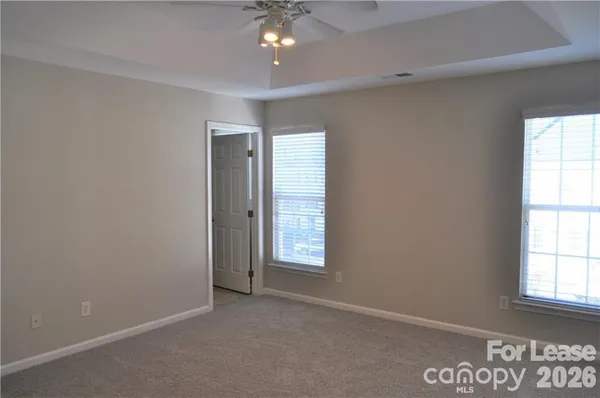 an empty room with windows and closet