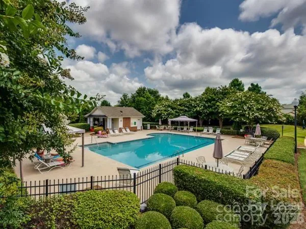 a view of a house with pool and chairs