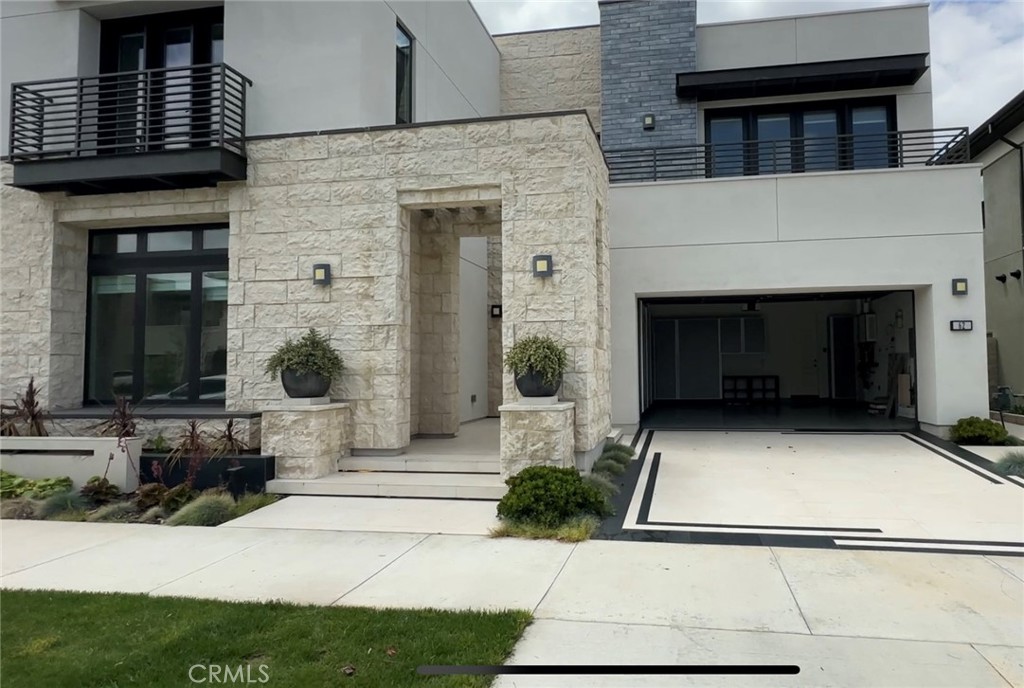 a front view of a house with potted plants