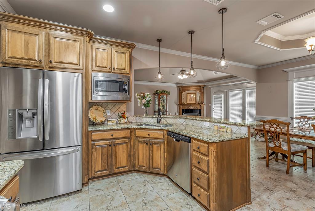 110 St Andrews Benton, LA 71006 - Photo 12 of 28 a kitchen with stainless steel appliances granite countertop a sink refrigerator and cabinets