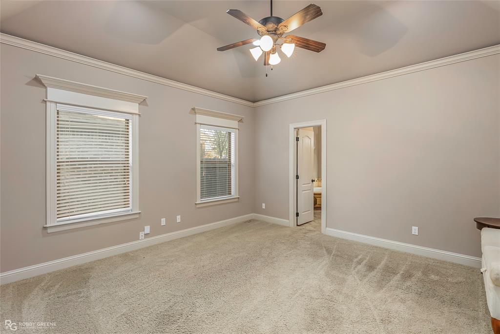 110 St Andrews Benton, LA 71006 - Photo 16 of 28 an empty room with chandelier fan and windows